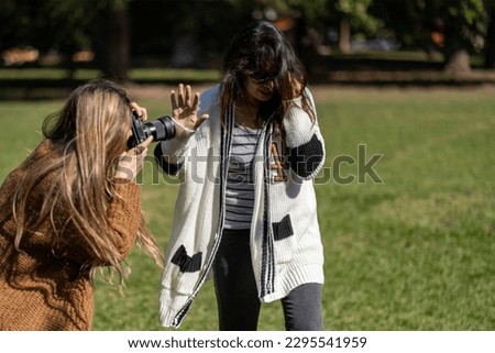 Woman rejecting paparazzi. Photographer trying to get a picture of person who refuses