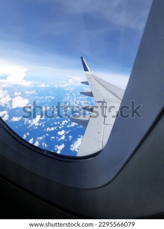 Pictures of blue skies and white clouds taken from behind airplane Windows