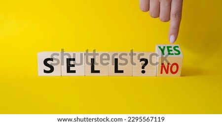 Sell Yes or No symbol. Businessman Hand points at wooden cubes with words Sell No or Sell Yes. Beautiful yellow background. Business and Sell concept. Copy space