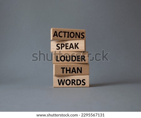 Actions speak louder than Words symbol. Wooden blocks with words Actions speak louder than Words. Beautiful grey background. Business and Actions concept. Copy space.