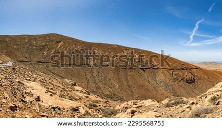 Stunning panoramic view of the road carved into and through the dramatic volcanic mountain landscape of Fuerteventura in the Canary Islands Spain