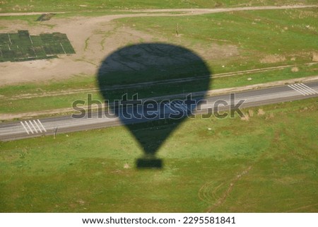 the shadow of a balloon on the ground