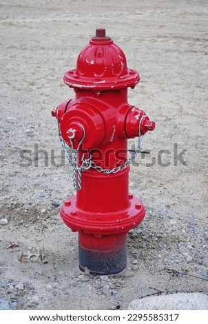 Newly installed bright red fire hydrant in construction site