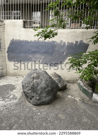 During the protests people wrote chants against the regime and its minions would color them. Thus solid rock is the symbol of Iranian people.