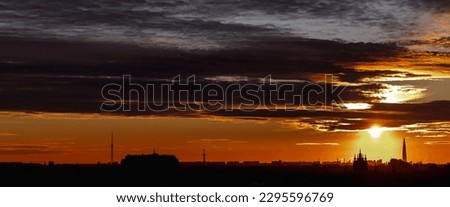 Panoramic view of silhouette cityscape at amazing city orange sunset background, skyline. Large aerial panorama of evening urban landscape for ad banner. Horizon of night city life. Copy text space
