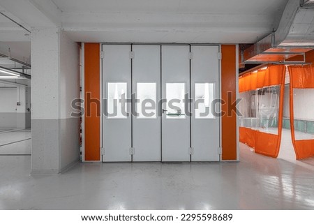 Car service concept. Spray paint cabinet for car body or vehicles painting or parts in a car repair station. Paint booth repair station.  Royalty-Free Stock Photo #2295598689