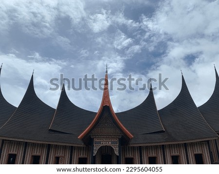 Rumah Gadang PDIKM is a Minangkabau cultural museum. The picture shows the form of a Minangkabau house called a Rumah Gadang. The roof of a Rumah Gadang is resembling the shape of a buffalo horn.