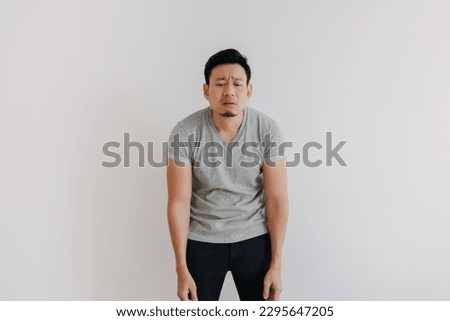 Full portrait of disappointed face Asian man advertising looking at empty space. Royalty-Free Stock Photo #2295647205