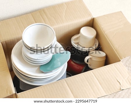 A lot of tableware in a cardboard box Royalty-Free Stock Photo #2295647719