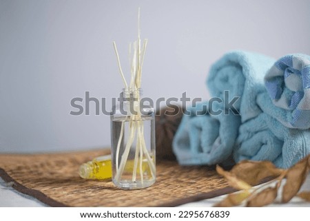 Aroma diffuser in a clear bottle placed next to a blue towel. to deodorize, not just wishing Royalty-Free Stock Photo #2295676839