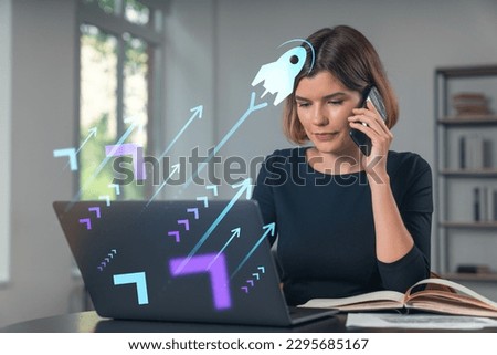 Pensive attractive beautiful businesswoman in formal wear working on laptop at office workplace in background. Concept of start up new business technology. Rocket icon hologram. Talking phone.