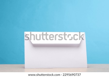 White envelope on the table, blue background