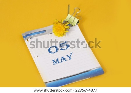 May 5 calendar: desk calendar with yellow dandelion, number 05, name of the month May in English, yellow background