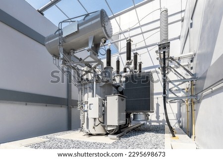 Power Transformer in High Voltage Electrical power electricity substation background. Royalty-Free Stock Photo #2295698673