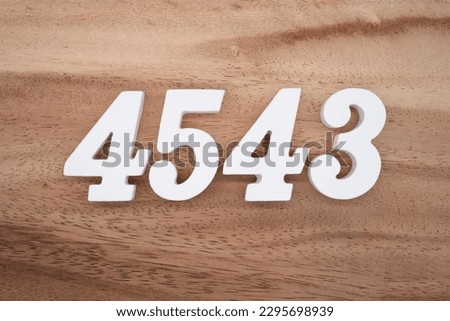 White number 4543 on a brown and light brown wooden background.