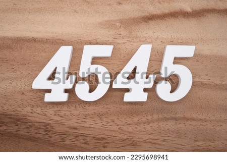 White number 4045 on a brown and light brown wooden background.