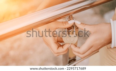 Hands, lock, heart, love, valentines day. Close-up of a woman's hands holding heart shaped padlock with a heart. The concept of Valentine's day, wedding, symbol of love and fidelity.