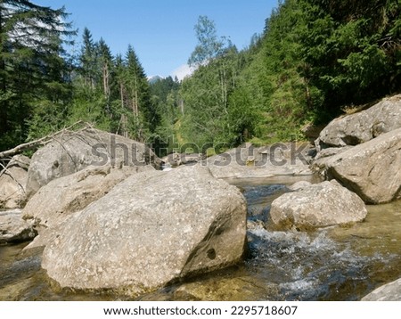 A rocky river bed in the European Alps.  Royalty-Free Stock Photo #2295718607