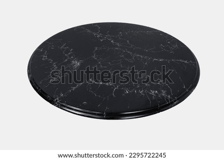 Round black marble table top slab isolated on white background, side view