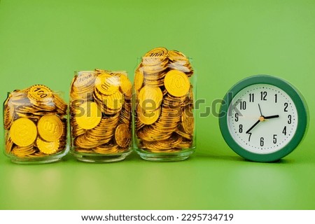 gold coins in a glass jar saving money coin coin bank income wages expenditure money financial stability