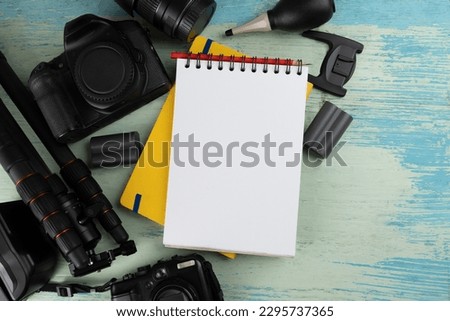 Mix of old cameras, equipment and accesseries on blue wooden desk background, photography concept