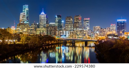 Philadelphia cityscape panorama by night. Schuylkill river reflects the colorful skyscrapers