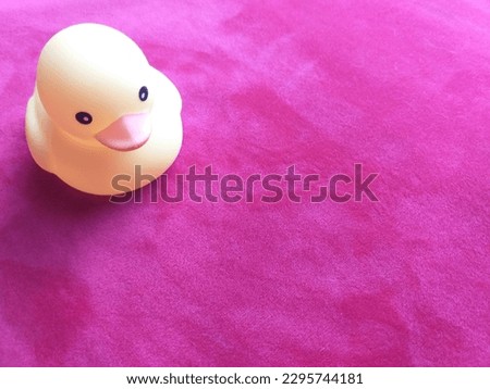 Yellow duck on table red Capet
