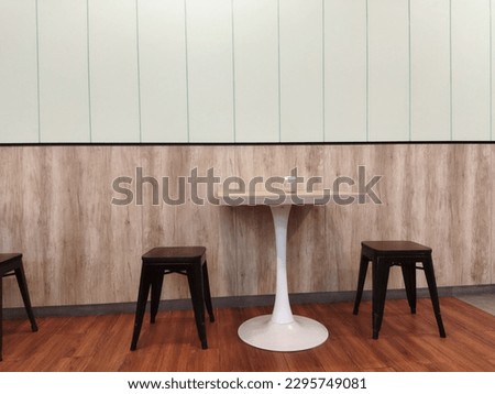 a simple minimalist concept table chair setting in the interior of a small cafe