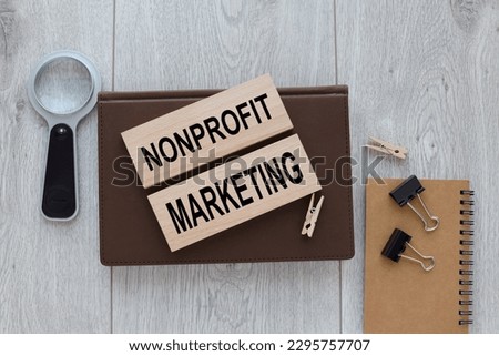 Nonprofit Marketing two wooden blocks on a brown notepad on a wooden table