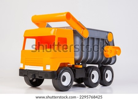 Career truck. Multi-colored children's toys plastic trucks on a white background.