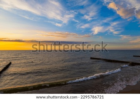 Scenic sunset sea landscape. Surfline with waves, dramatic sky and horizon at sunset time