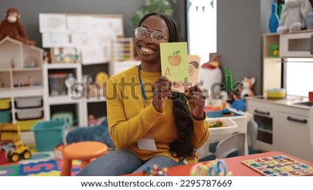 African woman preschool teacher on a vocabulary lesson at kindergarten Royalty-Free Stock Photo #2295787669