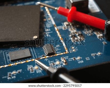 Electronic circuit board with testing equipment. Digital technology concept.