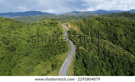 Road in the forest on the top of the mountain Bird eye view By Drone Royalty-Free Stock Photo #2295804879