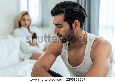 Caucasian young couple sit on bed with painful after fight argument. New marriage man and woman crying and feel heartbroken for their quarrel conflict in bedroom. Family problem-separation concept. Royalty-Free Stock Photo #2295818529