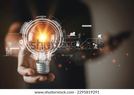 Man holding light bulb with energy power icons. Energy power electric environment from nature. innovation ecology electricity. Electricity reduction to reduce global warming concept.