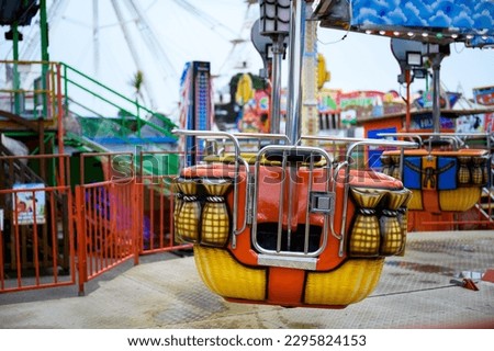 Daytime British colorful carnival fair amusement park rides Royalty-Free Stock Photo #2295824153