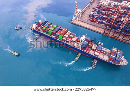 Aerial top view of Logistics and transportation of Container Cargo ship and Cargo plane with working crane bridge in shipyard. Royalty-Free Stock Photo #2295826499