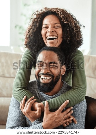 Portrait of a lovely young couple having fun and laughing together at home