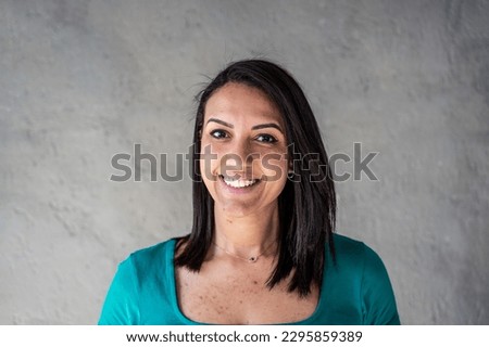 Portrait of happy north african woman - Confident and smiling young moroccan woman with smooth hair and peculiar teeth having fun while posing in front of the camera - Young generations concept Royalty-Free Stock Photo #2295859389
