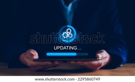Operating system upgrade concept, installation app and software update process, modernize user equipment, update modern functions, developer released new version Improved security. User is downloading Royalty-Free Stock Photo #2295860749