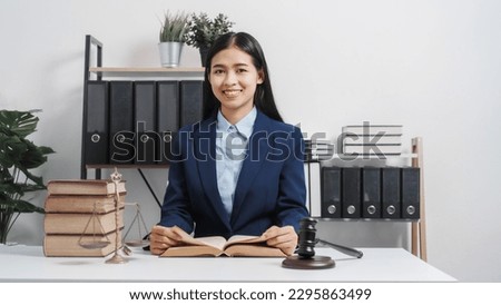 Young single female lawyer asian people in formal suit real estate working law book and contract documents, Arguments for Defense Strategy. Fight for Freedom. Supporting Evidence.