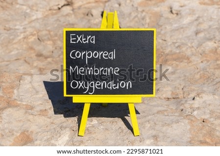 ECMO Extra Corporeal Membrane Oxygenation symbol. Concept words ECMO Extra Corporeal Membrane Oxygenation on black chalk blackboard on beautiful stone background. Medical, ECMO concept. Copy space.