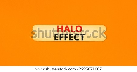 Halo effect and psychological symbol. Concept words Halo effect on beautiful wooden stick. Beautiful orange table orange background. Business psychological and Halo effect concept. Copy space.