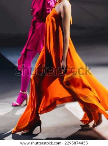 Fashion models woman wearing bright long orange pink summer dress. Casual stylish female clothes concept. Fashion week catwalk fashion details