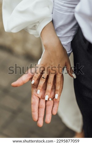 Picture of man and woman with wedding ring.Young married couple holding hands, ceremony wedding day. Newly wed couple's hands with wedding rings.