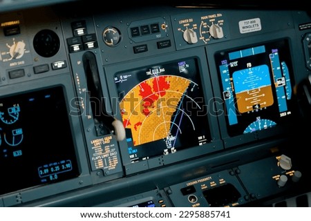 A detailed shot of the radar control and navigation panel in the cockpit of Boeing 737 Flight Simulator plane Royalty-Free Stock Photo #2295885741