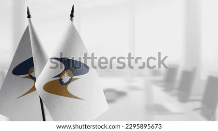 Small flags of the Eurasian Economic Union on an abstract blurry background. Royalty-Free Stock Photo #2295895673