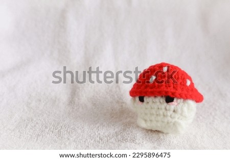 cute mushroom shaped amigurumi or crochet plush, doll isolated in whaite background
