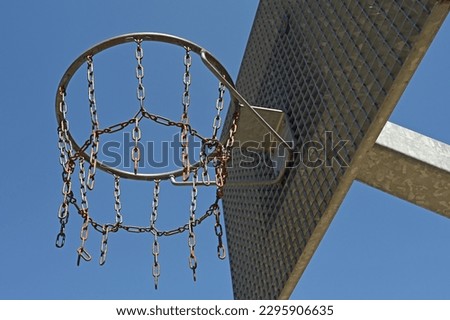 Metal basketball hoop against a clear blue sky